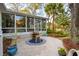 Sunroom with a table made from a barrel with a concrete patio and surrounding trees at 630 Cain Dr, Mount Pleasant, SC 29464