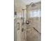 Luxurious shower with built-in seat, handrails, and decorative tile surround at 630 Cain Dr, Mount Pleasant, SC 29464