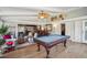 Well-lit sunroom featuring a pool table, comfortable seating, and charming decorative accents at 630 Cain Dr, Mount Pleasant, SC 29464