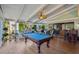 Bright sunroom with hardwood floors, a pool table, and views of the lush outdoor surroundings at 630 Cain Dr, Mount Pleasant, SC 29464