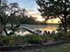 Beautiful waterfront property featuring lush landscaping and a dock with boat, kayak, and seating at 630 Cain Dr, Mount Pleasant, SC 29464