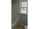 Bright bathroom featuring a shower-tub, toilet, and window for natural light at 708 Old State Rd, Goose Creek, SC 29445