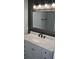 Bathroom vanity featuring white marble countertop, storage, and modern fixtures at 708 Old State Rd, Goose Creek, SC 29445