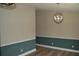 Dining room featuring two-tone walls, modern light fixture, and wood-look flooring at 708 Old State Rd, Goose Creek, SC 29445