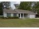 Charming single-story home with light gray siding, black shutters, and a well-manicured lawn at 708 Old State Rd, Goose Creek, SC 29445