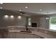 Open kitchen and living area with stone counters and modern lighting at 708 Old State Rd, Goose Creek, SC 29445
