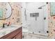 Modern bathroom with marble floors, glass shower, and uniquely patterned wallpaper at 78 Society St, Charleston, SC 29401