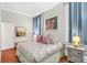 Inviting bedroom with patterned bedding, unique wall art, and soft lighting at 78 Society St, Charleston, SC 29401