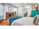 Elegant bedroom boasts a fireplace, a turquoise cabinet, and a relaxing bathtub area at 78 Society St, Charleston, SC 29401