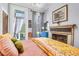 Bright bedroom with access to private balcony and fireplace at 78 Society St, Charleston, SC 29401