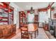 Elegant dining room with a bead chandelier, hardwood floors, and built-in wooden bookcases at 78 Society St, Charleston, SC 29401