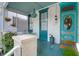 Cozy front porch with turquoise accents, bead chandelier, and an inviting outdoor seating area at 78 Society St, Charleston, SC 29401