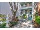 Beautifully landscaped yard and white home featuring double porches and a welcoming stone walkway at 78 Society St, Charleston, SC 29401