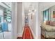 Hallway leading to the bedroom and kitchen with wood floors and decorative light fixture at 78 Society St, Charleston, SC 29401