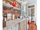 Quaint kitchen with marble counters, brick wall, and classic appliances at 78 Society St, Charleston, SC 29401