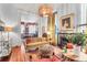 Cozy living room with fireplace, sofa, patterned ottoman, and decorative lighting fixture and adjacent view of the dining room at 78 Society St, Charleston, SC 29401
