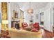 Stylishly decorated living room with fireplace, sofa, patterned ottoman, and ample lighting at 78 Society St, Charleston, SC 29401