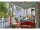 Charming porch offers seating and views of surrounding greenery and the neighborhood at 78 Society St, Charleston, SC 29401