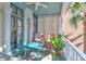 Relaxing porch features colorful furniture, decorative columns, and views of lush greenery at 78 Society St, Charleston, SC 29401