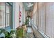 Enclosed porch offers a bench and shelving with decor, bringing the outdoors in at 78 Society St, Charleston, SC 29401