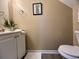 Half bath with white vanity, neutral walls, and decorative art provides convenience for guests at 7870 Nummie Ct, North Charleston, SC 29418