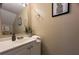 Bathroom sink vanity with modern fixtures, mirror, and plant art at 7870 Nummie Ct, North Charleston, SC 29418