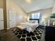 Cozy bedroom with vaulted ceiling, patterned rug, neutral decor, and natural light at 7870 Nummie Ct, North Charleston, SC 29418