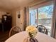 Bright dining area with striped tablecloth, a view of the backyard, and a sliding glass door at 7870 Nummie Ct, North Charleston, SC 29418