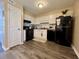 Spacious kitchen with white cabinets, modern appliances, and hardwood floors at 7870 Nummie Ct, North Charleston, SC 29418