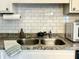 Clean kitchen sink with subway tile backsplash and gray countertops at 7870 Nummie Ct, North Charleston, SC 29418