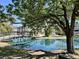 Scenic pond view with a bridge and lush trees, showcasing a peaceful community space at 7870 Nummie Ct, North Charleston, SC 29418