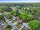 Aerial view of neighborhood with lush greenery, showcasing property with boat and cars in the driveway at 8147 Waltham Rd, North Charleston, SC 29406