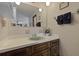 Bathroom featuring a sink with a wood cabinet and mirror with access to other rooms at 8147 Waltham Rd, North Charleston, SC 29406