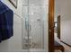 Tiled shower with built in seat and a glass door, with towel rack on the wall at 8147 Waltham Rd, North Charleston, SC 29406