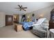 Comfortable bedroom with plush carpet, ceiling fan, blue accents, and entry to bathroom at 8147 Waltham Rd, North Charleston, SC 29406
