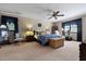 Comfortable bedroom with plush carpet, ceiling fan, two windows and beautiful blue accents at 8147 Waltham Rd, North Charleston, SC 29406