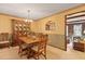 Traditional dining room with wooden furniture, patterned wallpaper, and a view into the living room at 8147 Waltham Rd, North Charleston, SC 29406