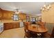 Eat in kitchen area with wooden cabinets, tile countertops, stainless steel appliances, and stylish chandelier at 8147 Waltham Rd, North Charleston, SC 29406