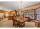Bright kitchen with wooden cabinets, tile countertops, a bay window, and eat in dining area at 8147 Waltham Rd, North Charleston, SC 29406