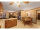 Open eat-in kitchen with wooden cabinets and views into the formal dining and living areas at 8147 Waltham Rd, North Charleston, SC 29406