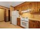 Functional kitchen featuring a white refrigerator, oven, and wooden cabinets with light countertops at 8147 Waltham Rd, North Charleston, SC 29406