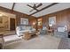 Spacious living room featuring wood paneling, neutral carpeting, and comfortable sofas and chairs at 8147 Waltham Rd, North Charleston, SC 29406