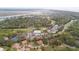 Expansive aerial shot of residential community, showing lush landscaping, golf course, and winding waterway views at 816 Club Cottage Rd, Edisto Beach, SC 29438