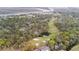 Picturesque aerial view of a golf course near waterfront homes, showcasing lush greenery and mature trees at 816 Club Cottage Rd, Edisto Beach, SC 29438