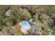 Overhead view of the pool, mini golf, and other recreational amenities surrounded by lush greenery and scenic pond views at 816 Club Cottage Rd, Edisto Beach, SC 29438