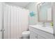 Bathroom featuring shower with curtain and white vanity with decorative mirror at 816 Club Cottage Rd, Edisto Beach, SC 29438