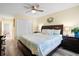 Bedroom featuring a large bed with a patterned quilt, ceiling fan, and an adjacent doorway at 816 Club Cottage Rd, Edisto Beach, SC 29438