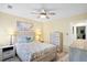 Bedroom with ceiling fan, light wood floors, and side tables with lamps at 816 Club Cottage Rd, Edisto Beach, SC 29438