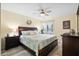 Bedroom featuring a large bed with a patterned quilt, ceiling fan, and wood-look flooring at 816 Club Cottage Rd, Edisto Beach, SC 29438