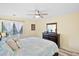 Bedroom showcasing a comfy bed, dresser, ceiling fan and bright natural light at 816 Club Cottage Rd, Edisto Beach, SC 29438